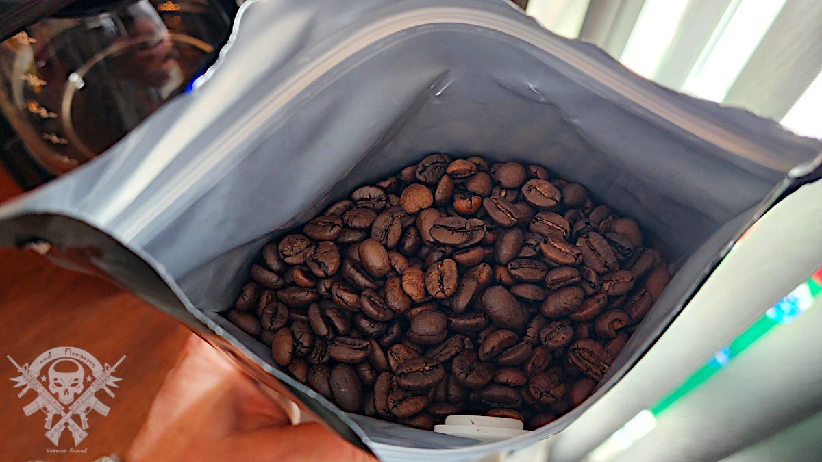 Fresh whole coffee beans inside an opened Gun Barrel Coffee MOAB bag.