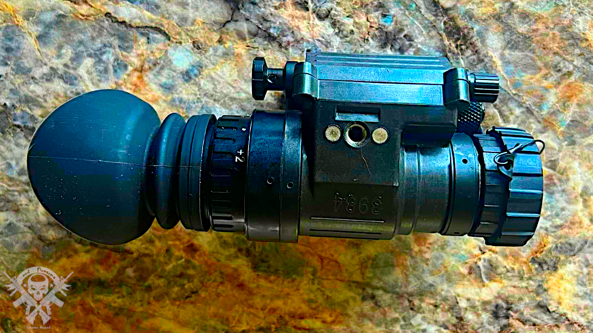 AGM PVS-14 Gen 3 night vision monocular side profile showing housing, eyepiece, and objective lens